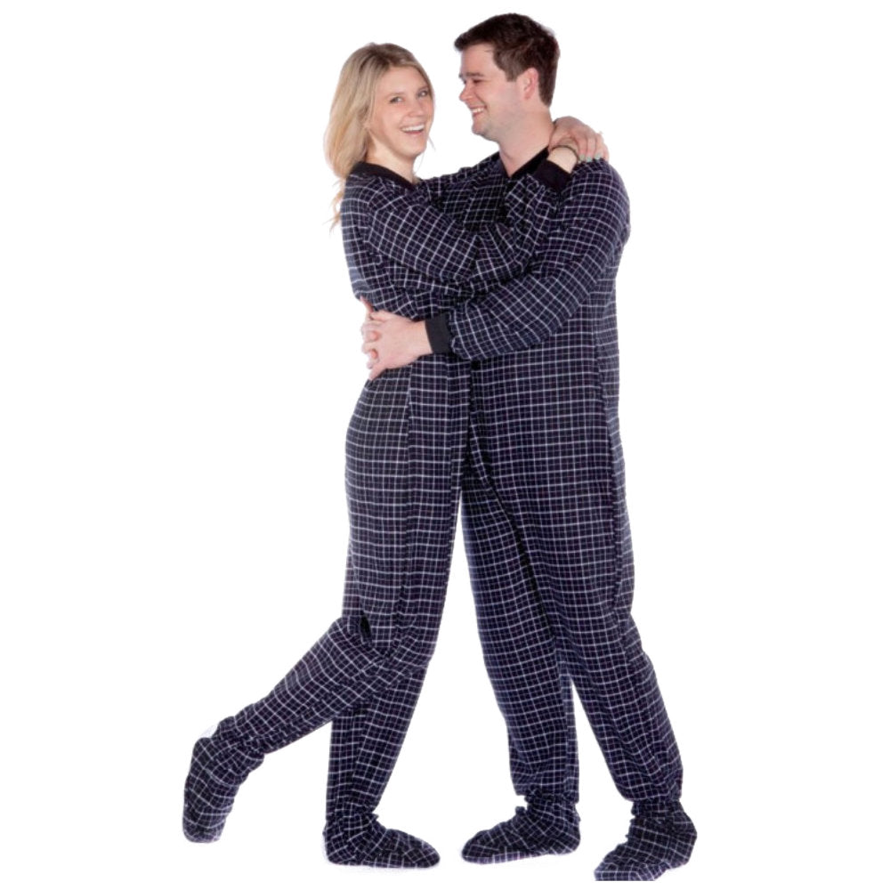 A couple is hugging wearing Black & White Windowpane Plaid Adult Footed Onesie Pajamas from Big Feet Pajama Company
