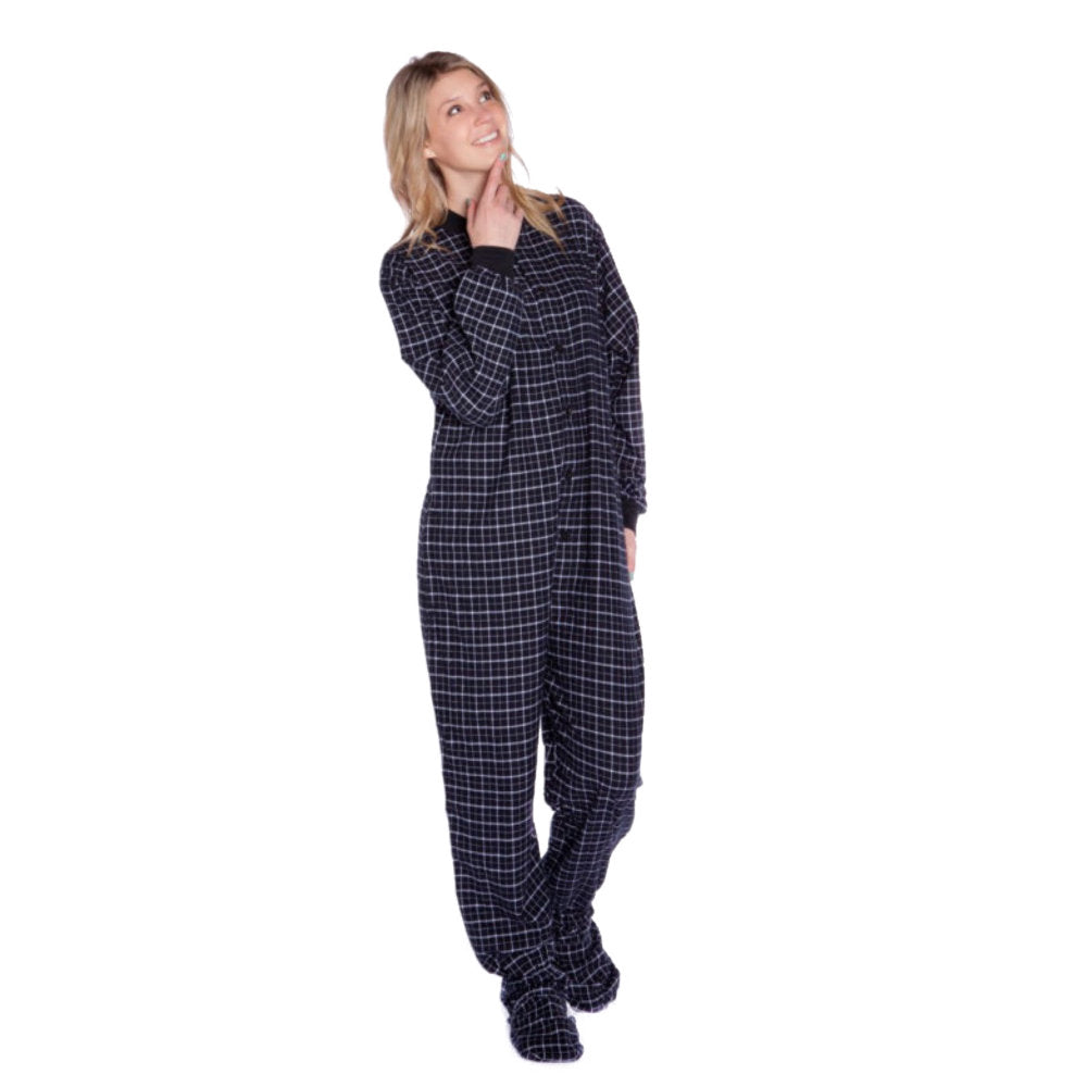 A woman wearing Black & White Windowpane Plaid Adult Footed Onesie Pajamas from Big Feet Pajama Cpmpany