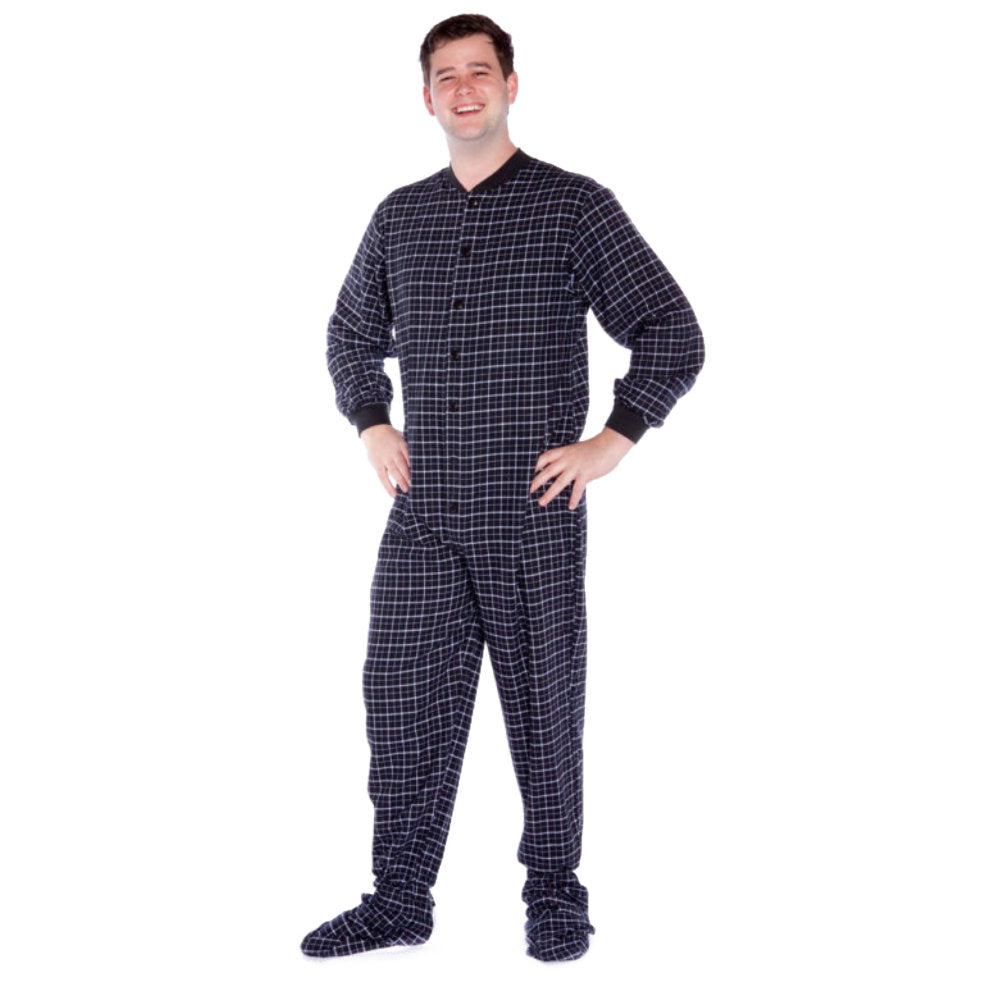 A man wearing Black & White Windowpane Plaid Adult Footed Onesie Pajamas from Big Feet Pajama Company