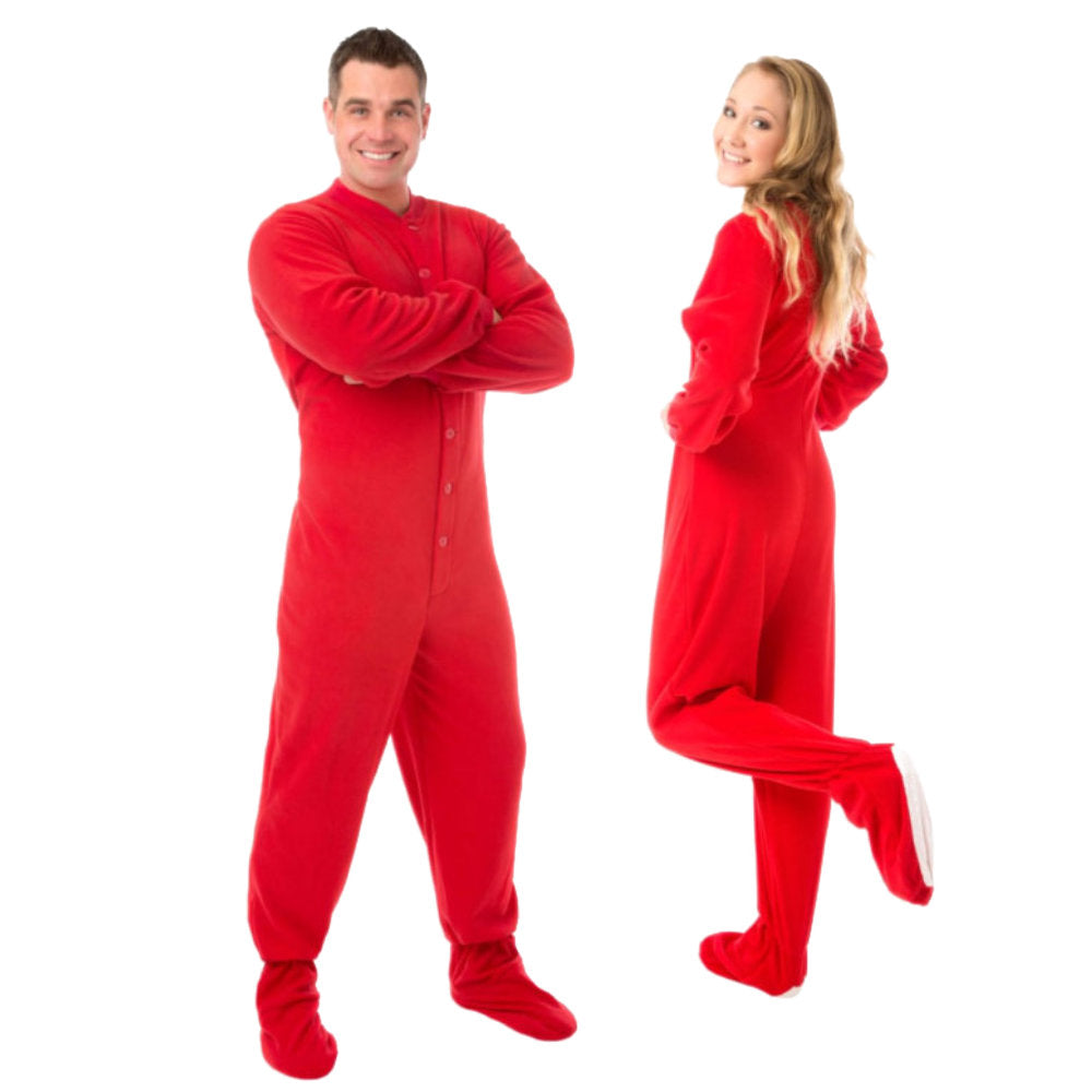 A man and woman couple wearing Red Fleece Adult Unisex Onesie Footed Pajamas from Big Feet Pajama Company.