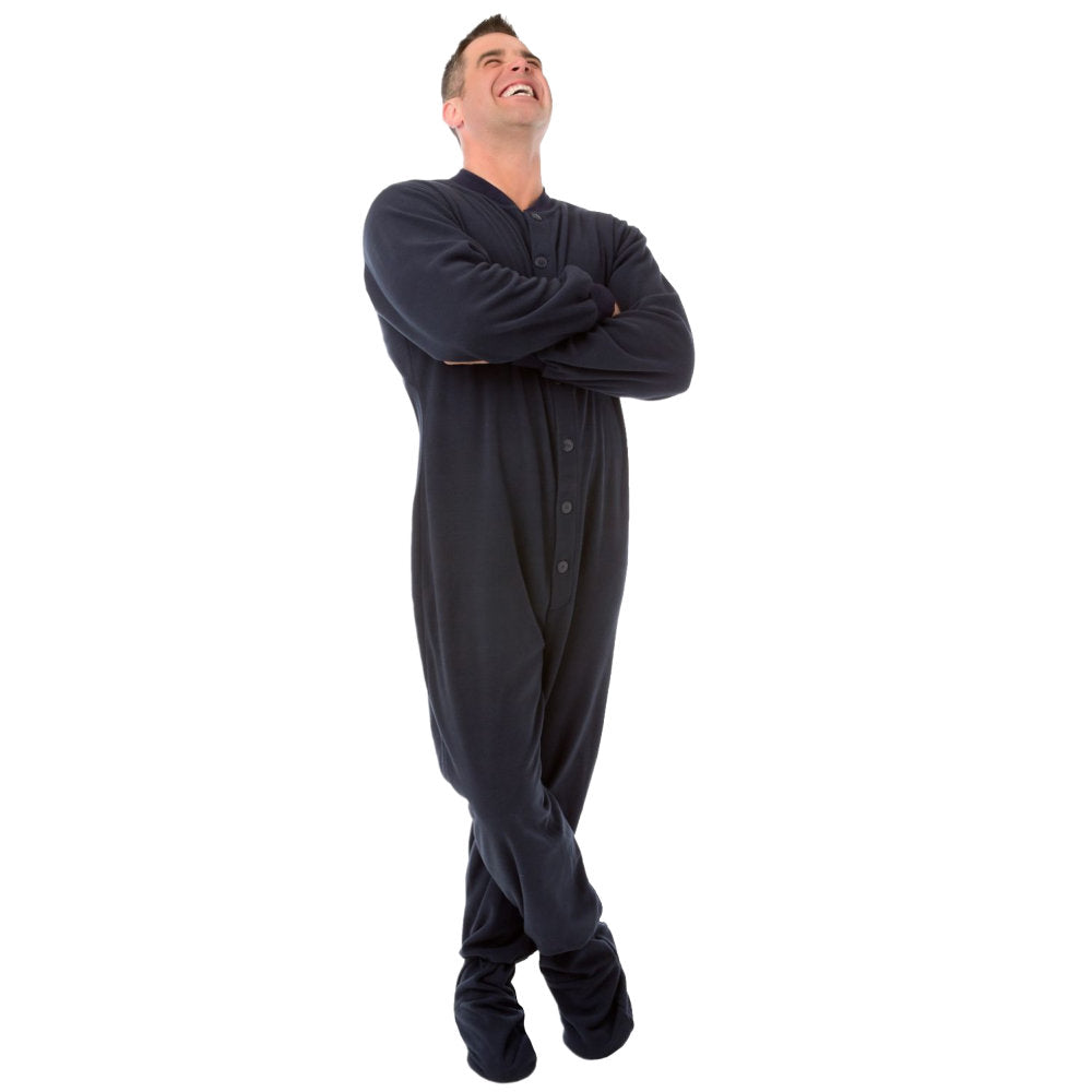 A man laughing with his arms crossed and wearing Navy Fleece Adult Onesie Footed Pajamas from Big Feet Pajama Company