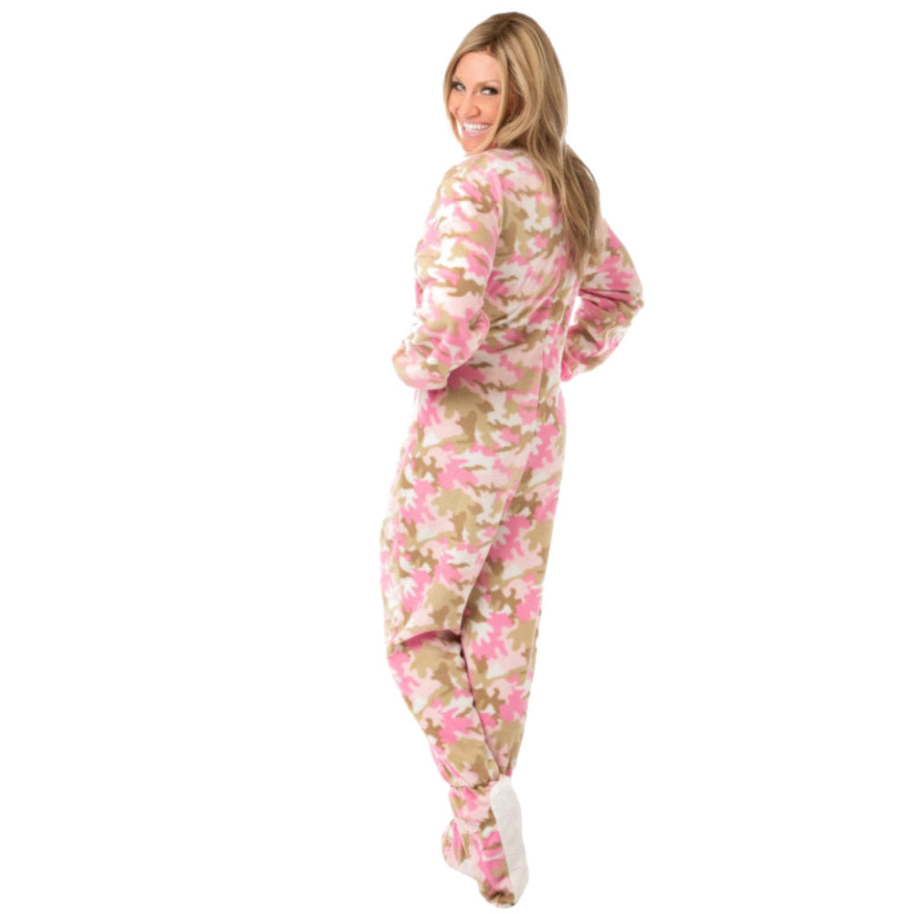 A woman smiling while turning wearing Pink Camouflage Fleece Adult Onesie Footed Pajamas for Women from Big Feet Pajama Company