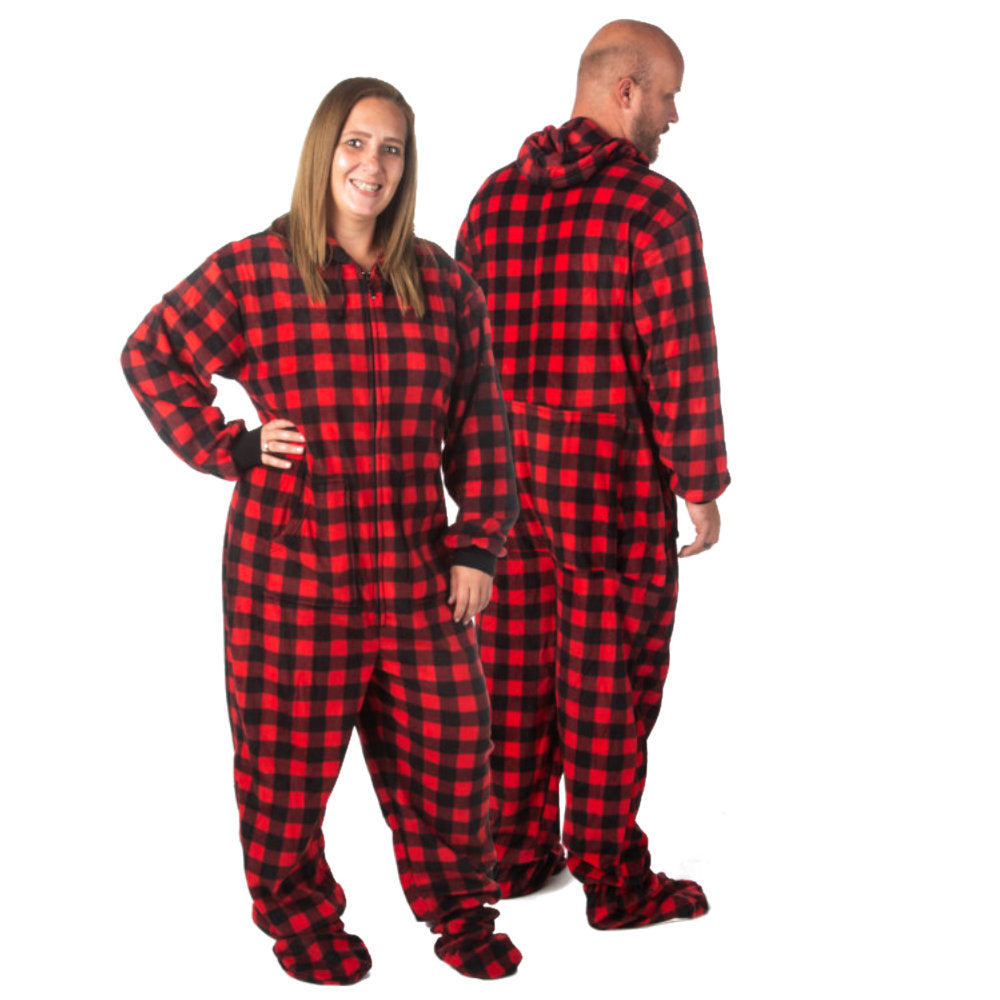 A man a woman couple wearing Matching Red and Black Buffalo Plaid Fleece Footed Onesie Pajamas from Big Feet Pajama Company