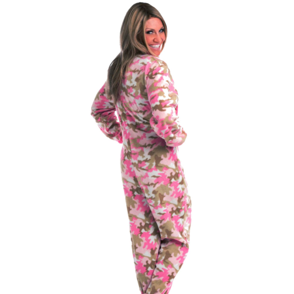 A woman smiling with hands on hips wearing Pink Camouflage Fleece Adult Onesie Footed Pajamas for Women from Big Feet Pajamas