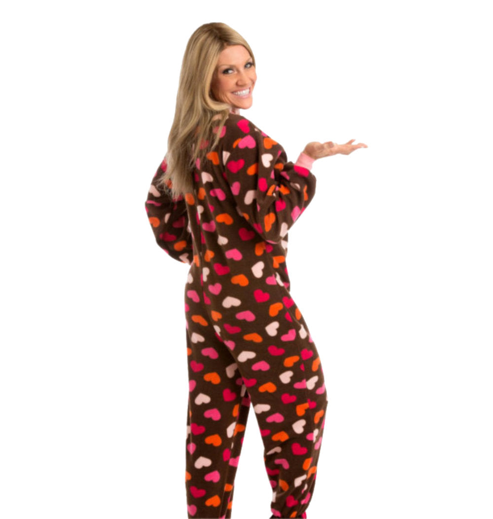 A woman wearing Brown Fleece Footless Onesie Pajamas with Pink, White, & Orange Hearts from Big Feet Pajama Company