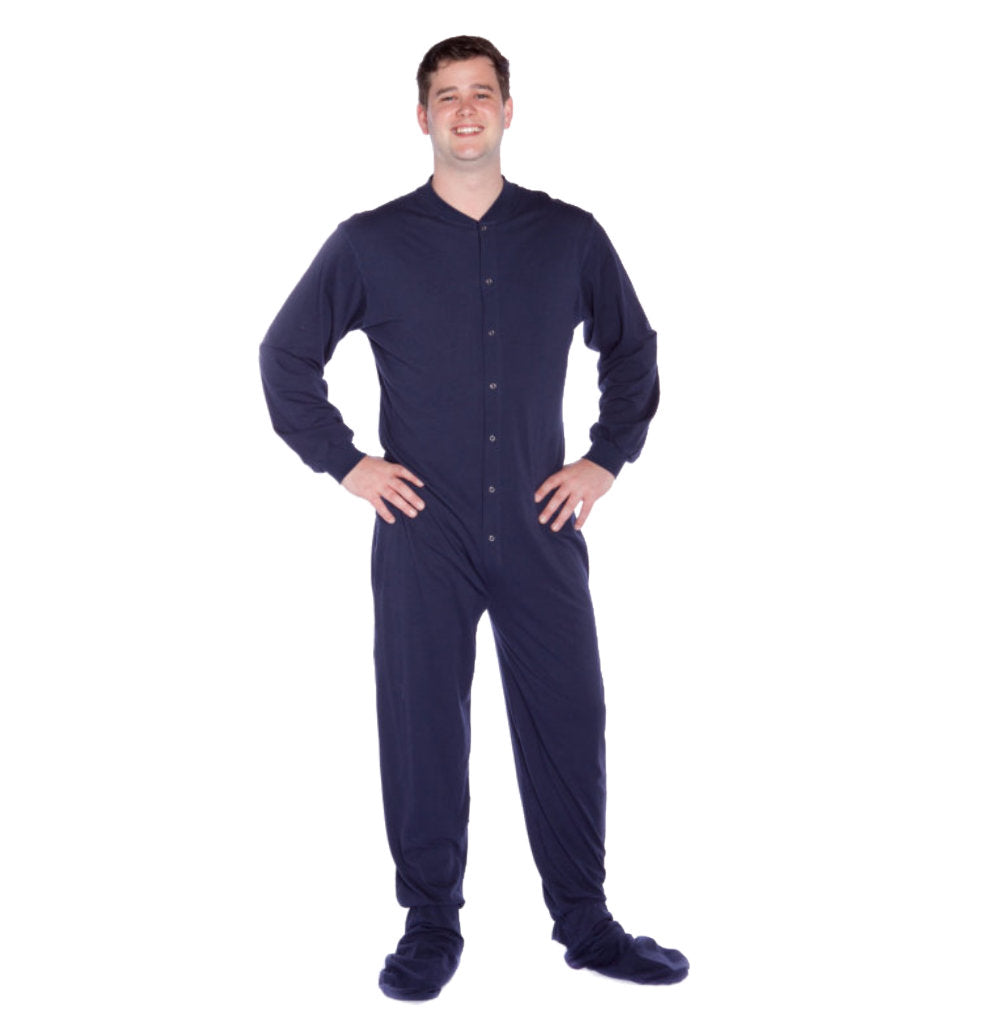 A man wearing Navy Blue Cotton Knit Adult Onesie Footed Pajamas for Men & Women from Big Feet Pajama Company.