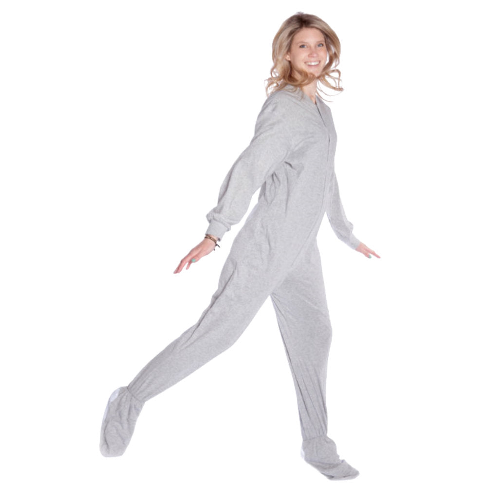A woman wearing light heather gray Cotton Knit Adult Onesie Footed Pajamas for Men & Women from Big Feet Pajama Company.