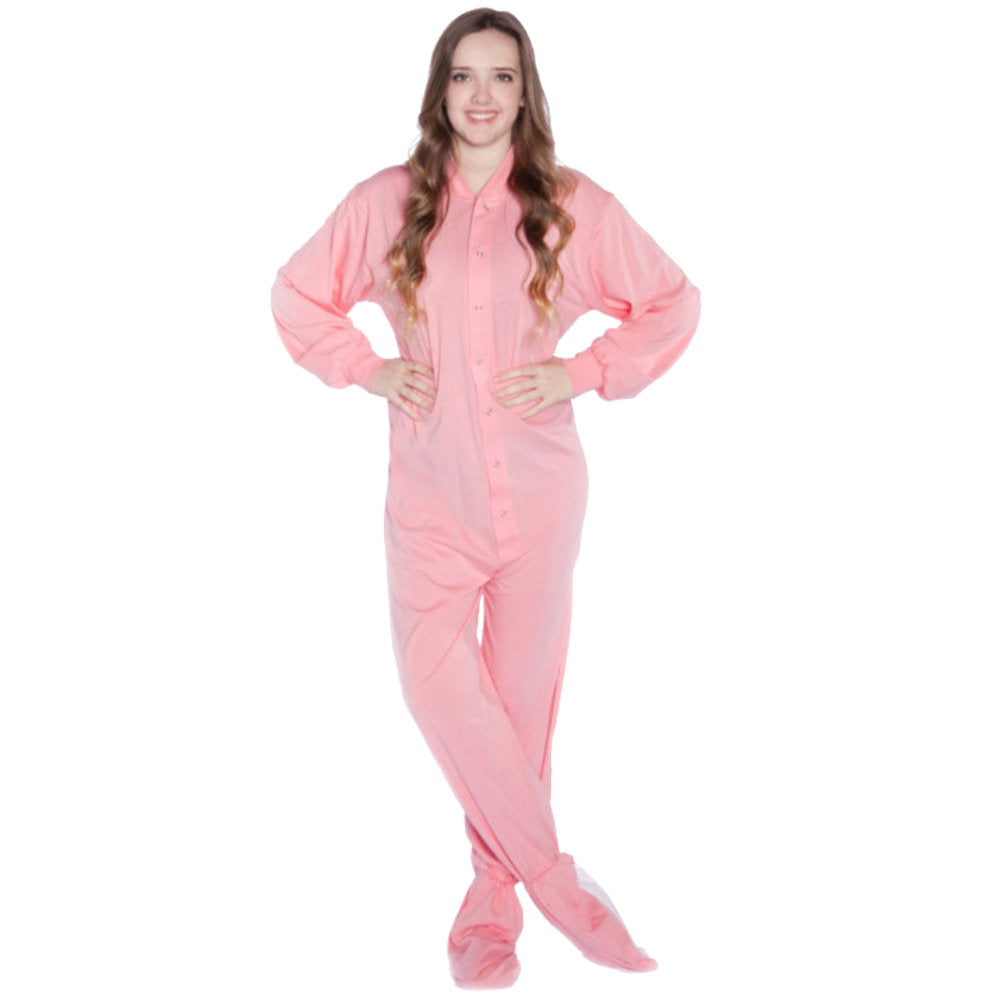 A woman wearing Pastel Pink Cotton Knit Adult Onesie Footed Pajamas for Men & Women from Big Feet Pajama Company.