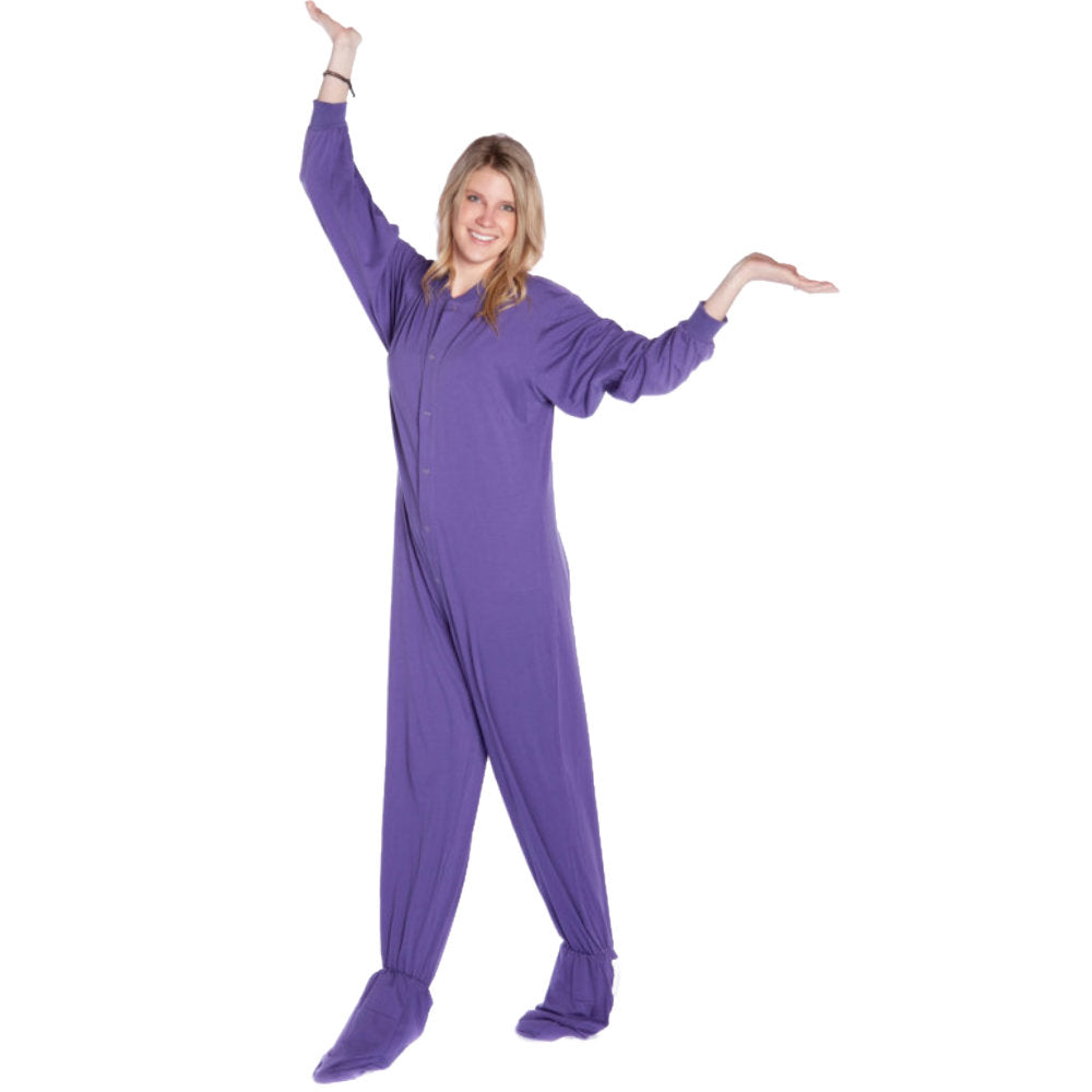 A woman wearing Purple Cotton Knit Adult Unisex Onesie Footed Pajamas for Men & Women from Big Feet Pajama Company.