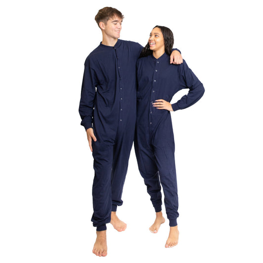 A couple wearing matching Navy Blue Cotton Knit Adult Footless Onesie Pajamas for Men & Women from Big Feet Pajama Company.