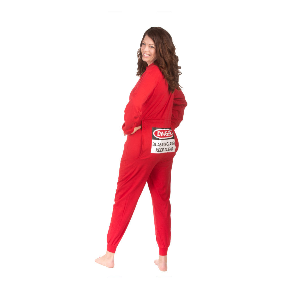 A woman wearing Red Cotton Knit Adult Footless Onesie Pajamas with Funny Butt-Flap that shows a warning sign on it that says "DANGER - BLASTING AREA - KEEP CLEAR" from Big Feet PJs.