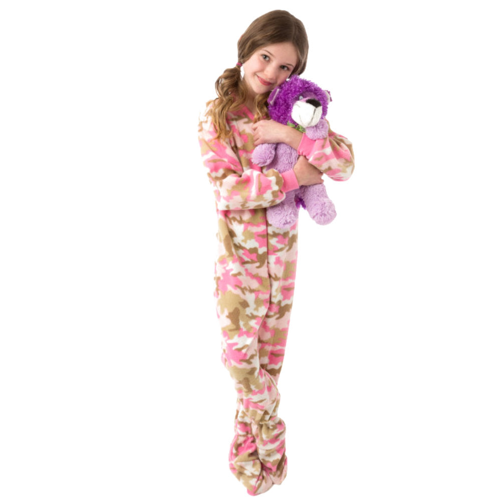 A young girl cuddling her bear in her her new winter pjs, Pink Camouflage Fleece Onesie Footie Pajamas for kids from Big Feet Pajama Company.
