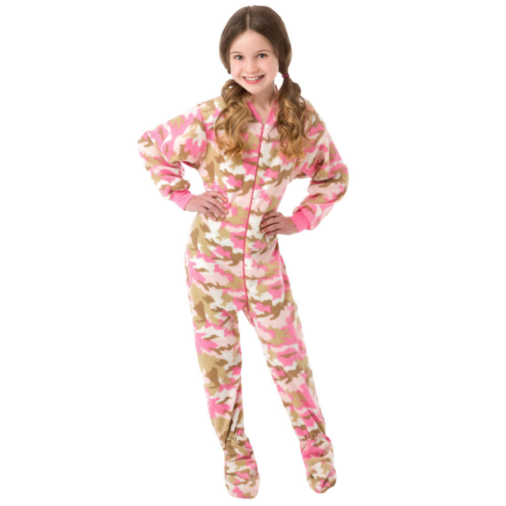 A young girl smiling wearing her Christmas PJs, Pink Camouflage Fleece Onesie Footie Pajamas for kids from Big Feet Pajama Company.