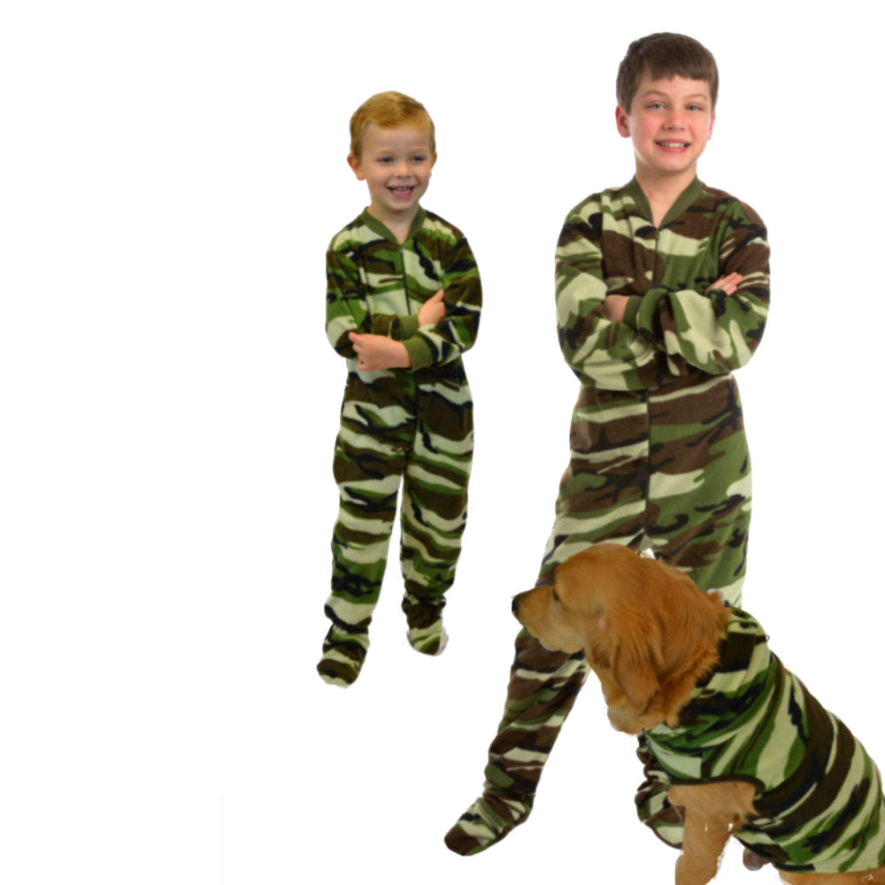 A boy, his little brother and their dog all wearing matching camouflage pajamas for families and pets from Big Feet Pajama Company.