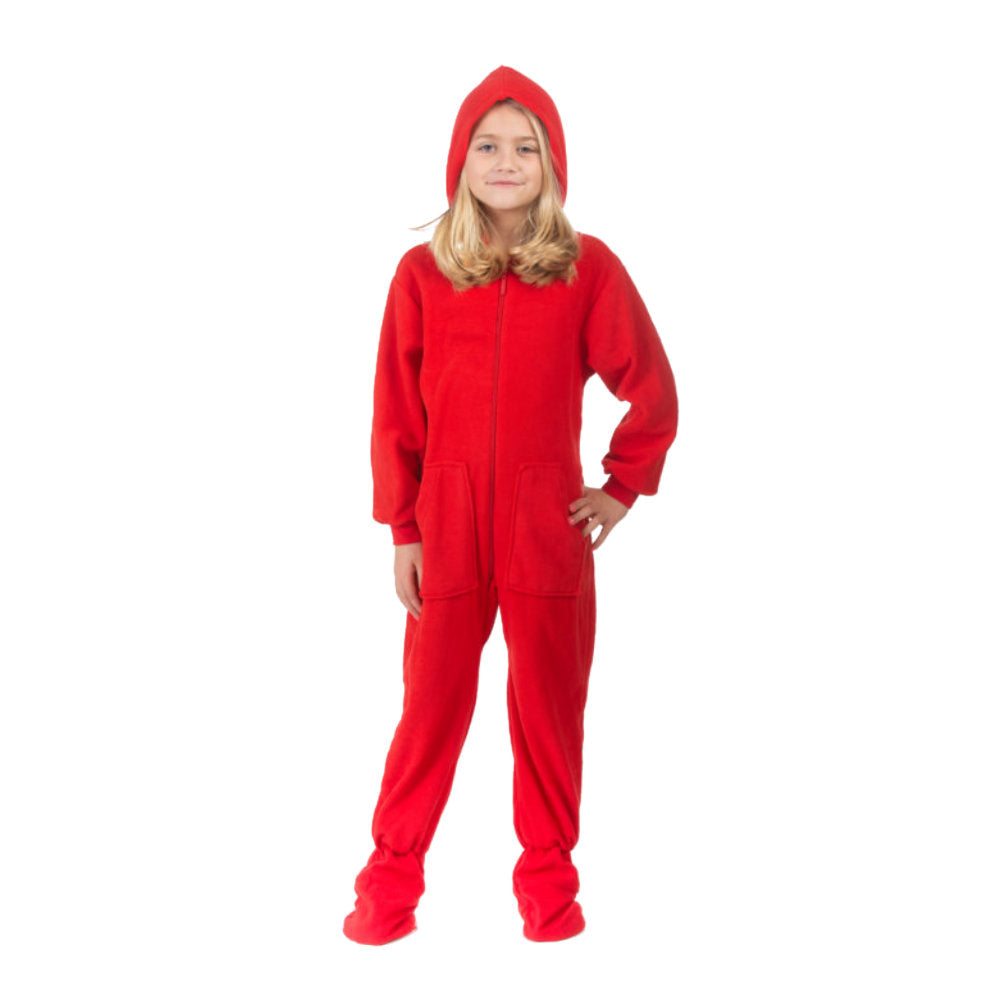A little girl posing for Christmas pictures. She has the hood up on her red fleece hoodie onesie-footed pajamas from the Big Feet Pajama Company.