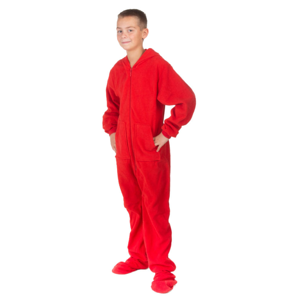 A boy wearing hoodie footed red fleece onesie pajamas from Big Feet Pajama Company.