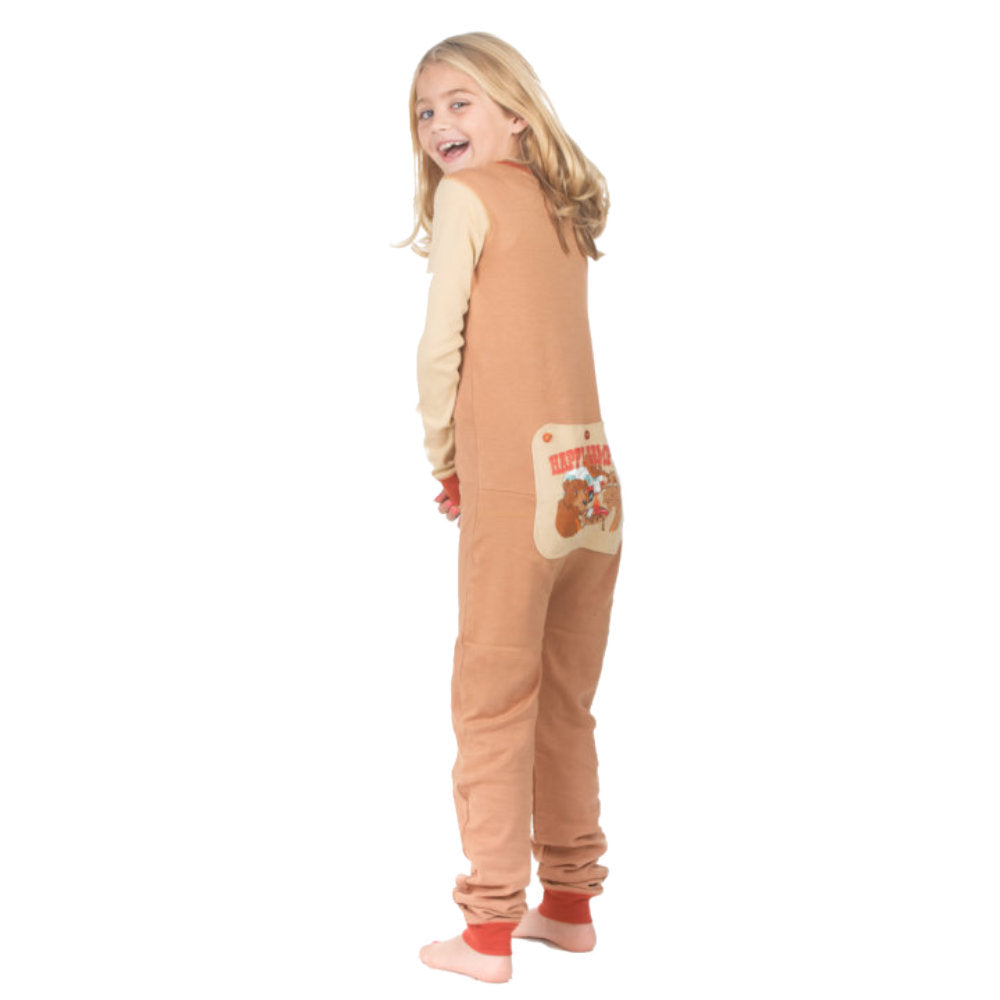 A young girl laughing wearing a brown and beige Happy Camper onesie from the Big Feet Pajama collection of 100% cotton Union Suit Sleepwear and Playwear. The onesies feature a "Happy Camper" badge on the chest. The onesies have long sleeves, cuffs, a snap-up front, and a decorative rear flap with the Happy Camper Bear and Moose by the fire at their campsite.