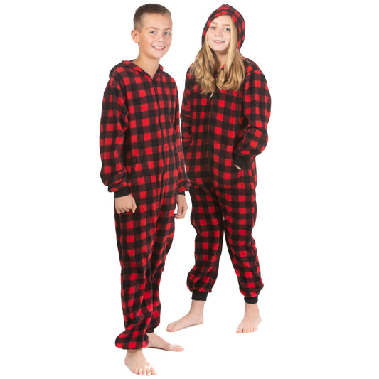 A boy and girl are wearing hoodie jumpsuit pjs from the Big Feet Pajama Company line of matching family onesies pajamas. This one-piece outfit is footless and made of Red and Black Buffalo plaid micro-polar fleece.