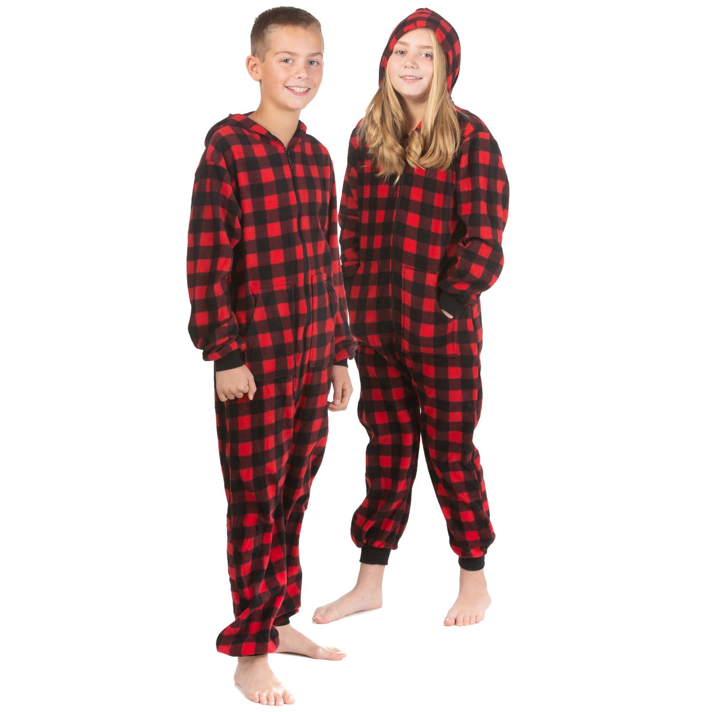 A boy and girl are wearing hoodie jumpsuit pjs from the Big Feet Pajama Company line of matching family onesies pajamas. This one-piece outfit is footless and made of Red and Black Buffalo plaid micro-polar fleece.