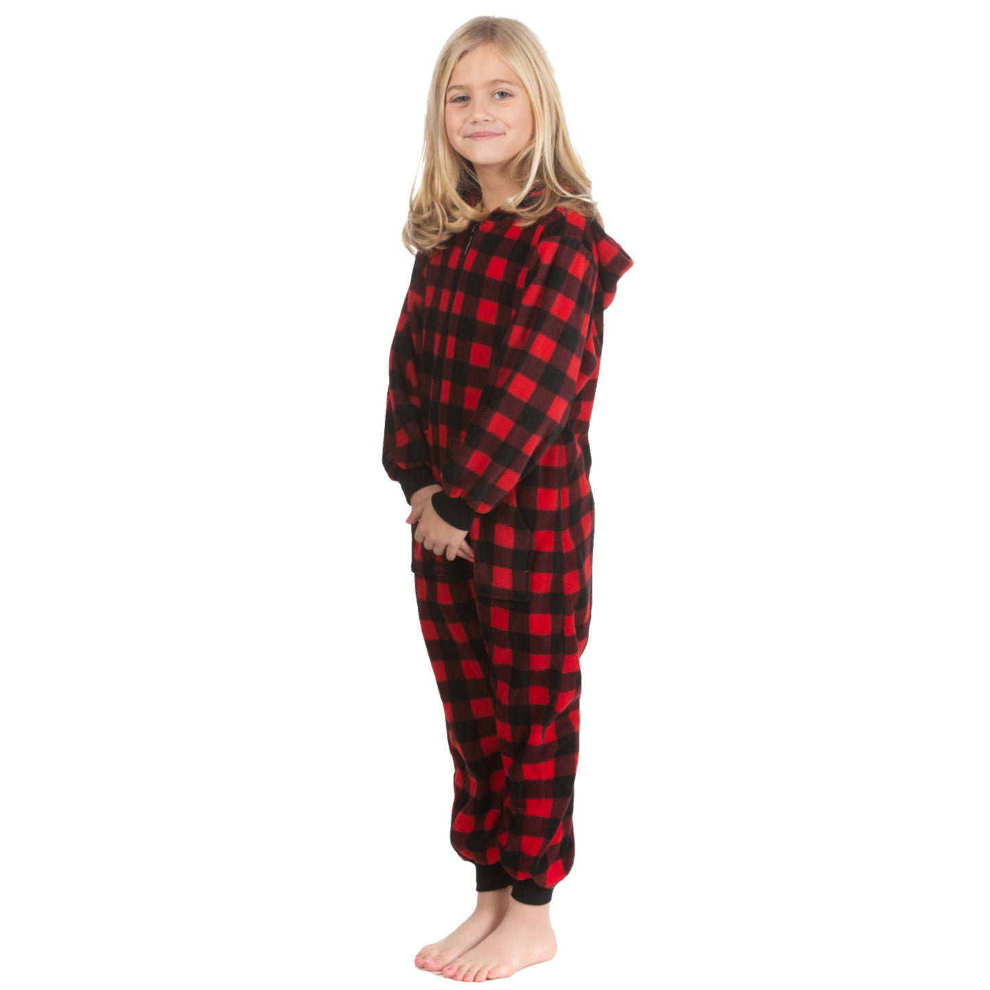 A girl is wearing one-piece jumpsuit-style pajamas from the Big Feet Pajama Company line of warm fleece footless onesies that make getting ready for bed and relaxing at home easy. This outfit is made of Red and Black Buffalo plaid polar fleece.