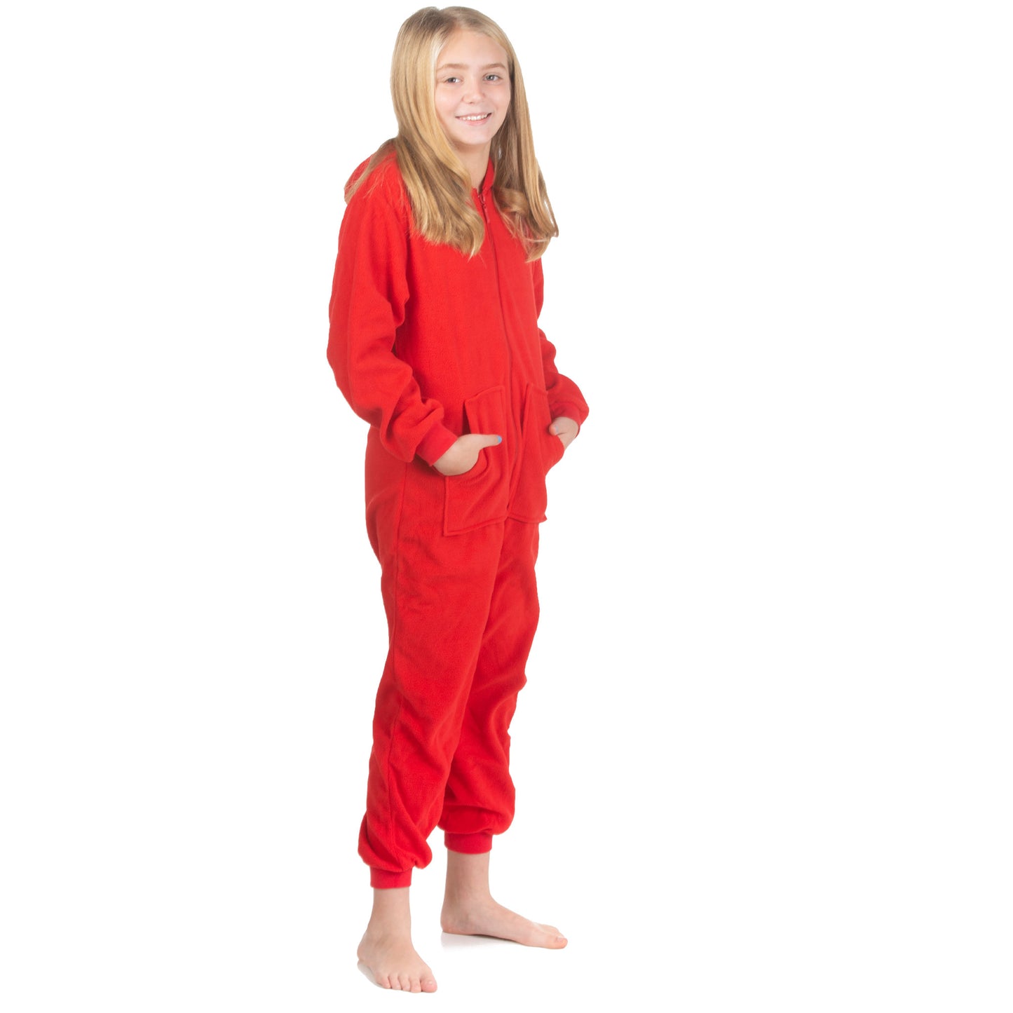 A teen girl is wearing one-piece pjs from the Big Feet Pajama Company line of comfy, fleece footless onesies that make getting ready for bed and relaxing at home easy. This outfit is made of red fleece, and she is posing with her hands in the kangaroo pockets.
