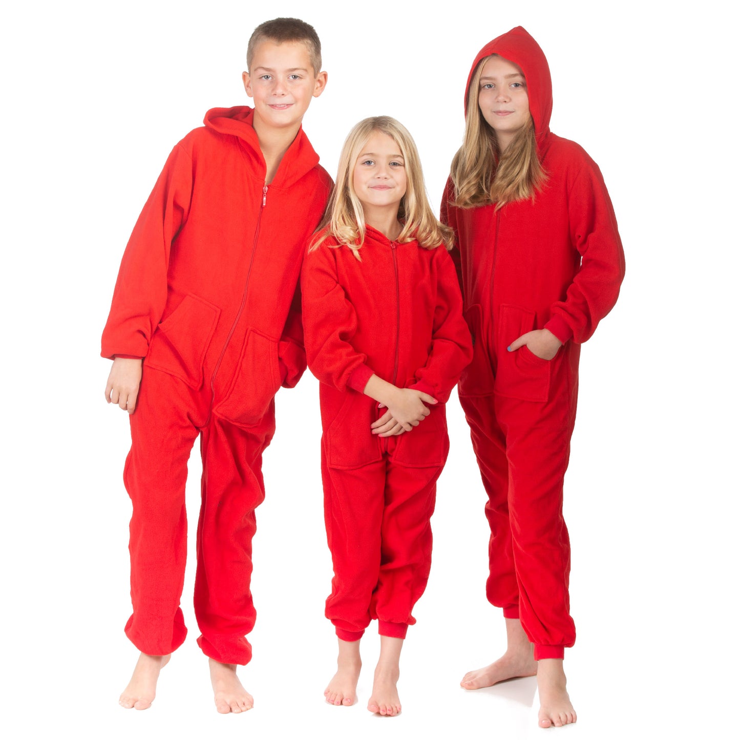 Teen boys and girls are wearing hoodie jumpsuit pjs from the Big Feet Pajama Company line of matching family onesies pajamas. These one-piece outfits are footless and made of Red polar fleece.