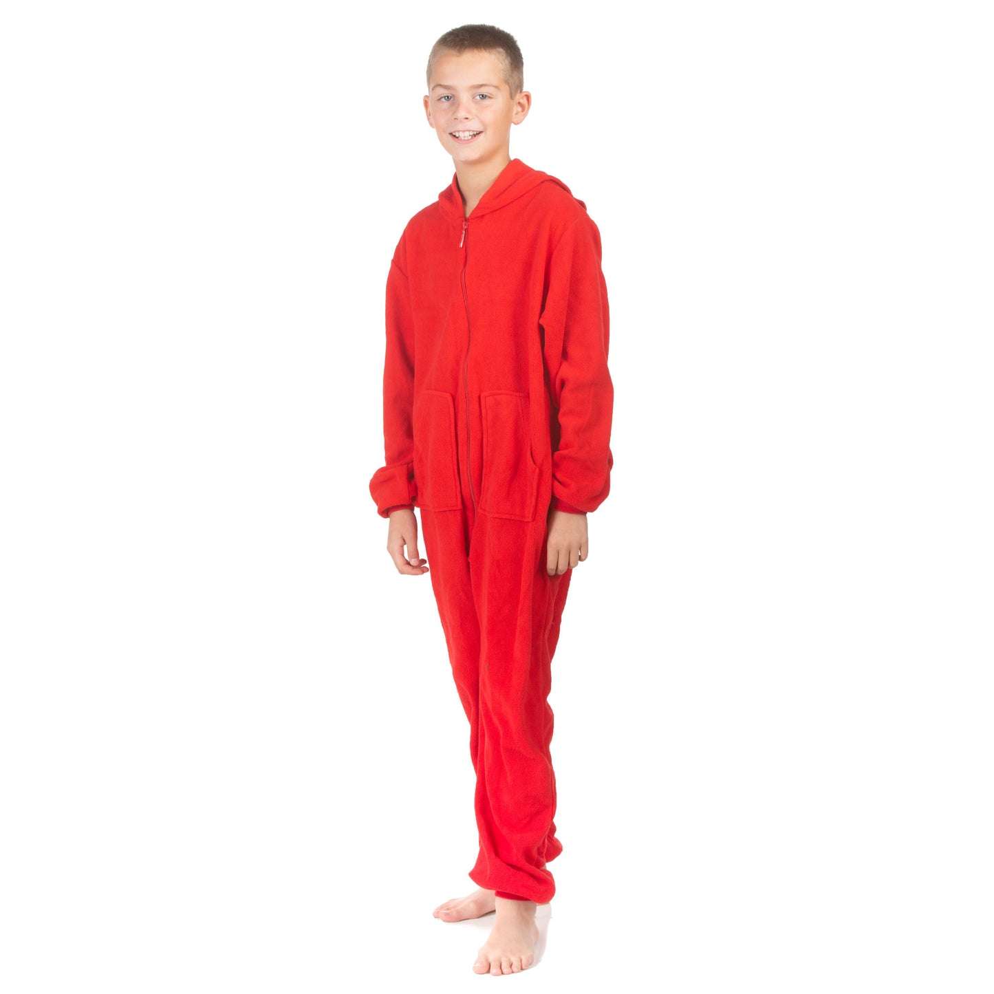 A teen boy is wearing one-piece jumpsuit-style pajamas from the Big Feet Pajama Company line of warm fleece footless onesies that make getting ready for bed and relaxing at home easy. This outfit is made of Red Micro-polar fleece.
