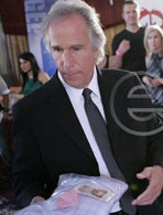 Actor Henry Winkler selecting footed onesie pajamas from Big Feet Pajama Company during The TV Land Awards