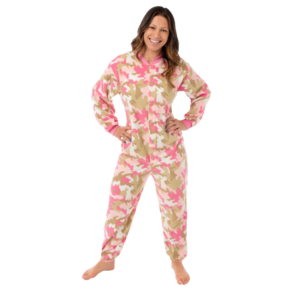 A woman wearing a pink and beige camouflage fleece onesie from Big Feet Pajamas.