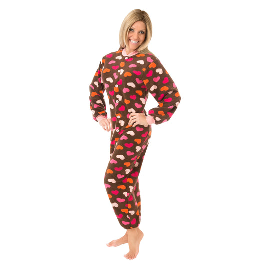 Woman wearing a brown onesie with colorful hearts