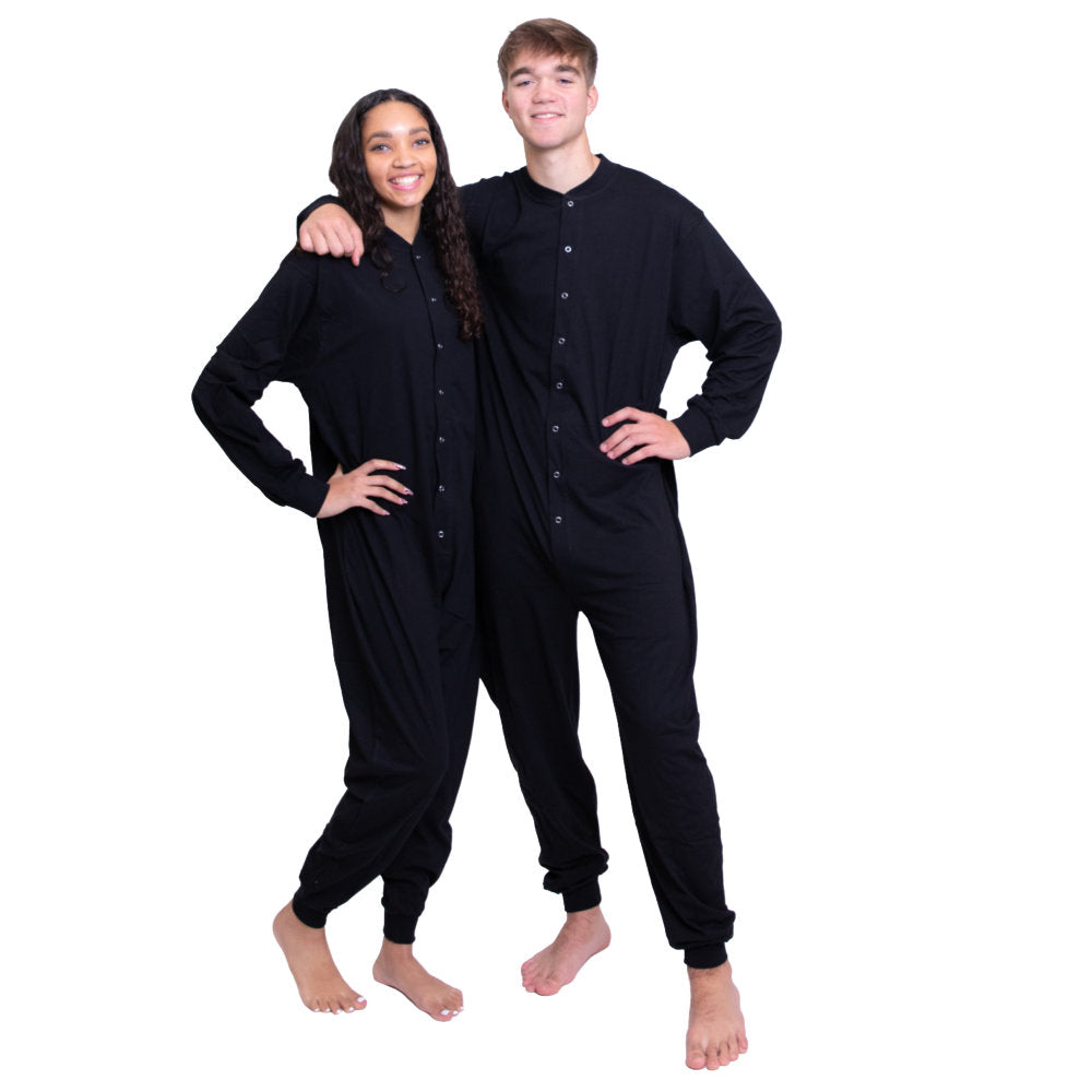 A couple wearing matching unisex Black Cotton Knit Adult Footless Union- Suit style Onesie Pajamas from Big Feet Pajama Compny.
