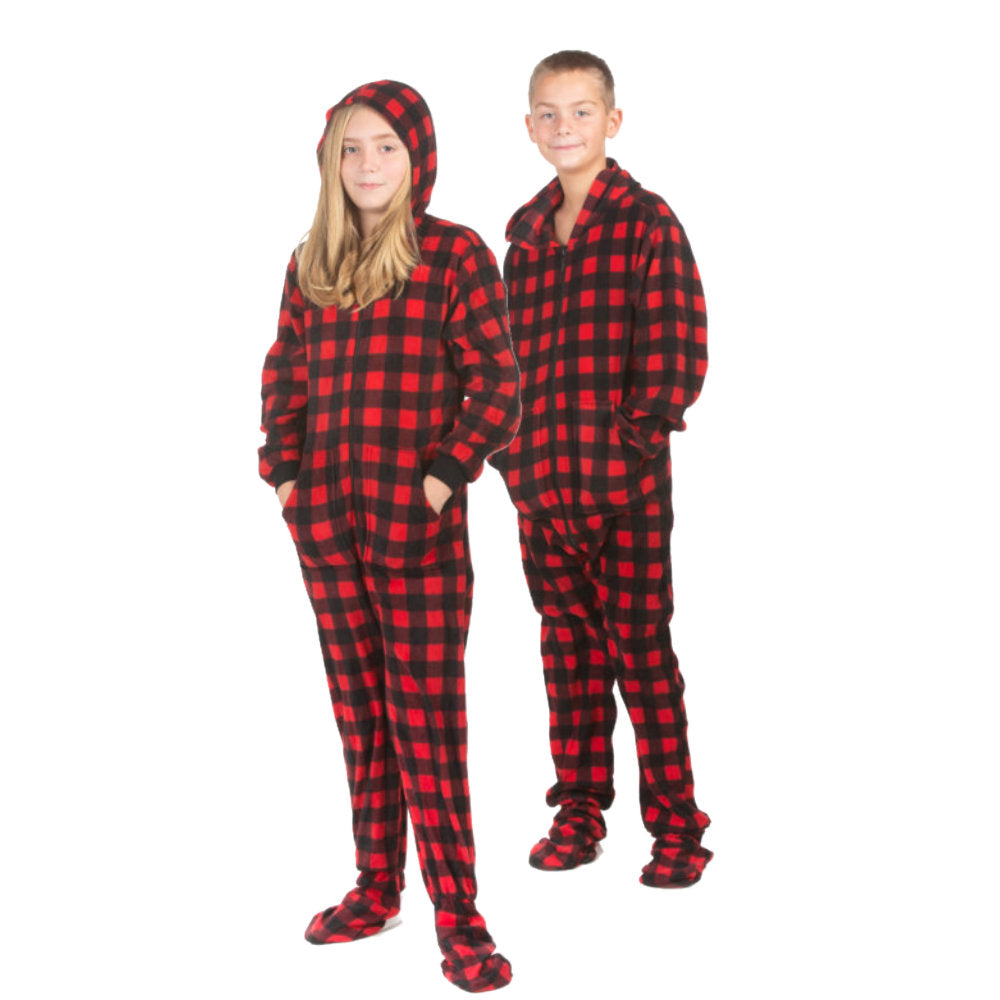 A sister and brother wearing matching pajamas for Christmas pictures; Hoodie Red & Black Buffalo Plaid Fleece Footed Onesie Pajamas from Big Feet Pajama Company.