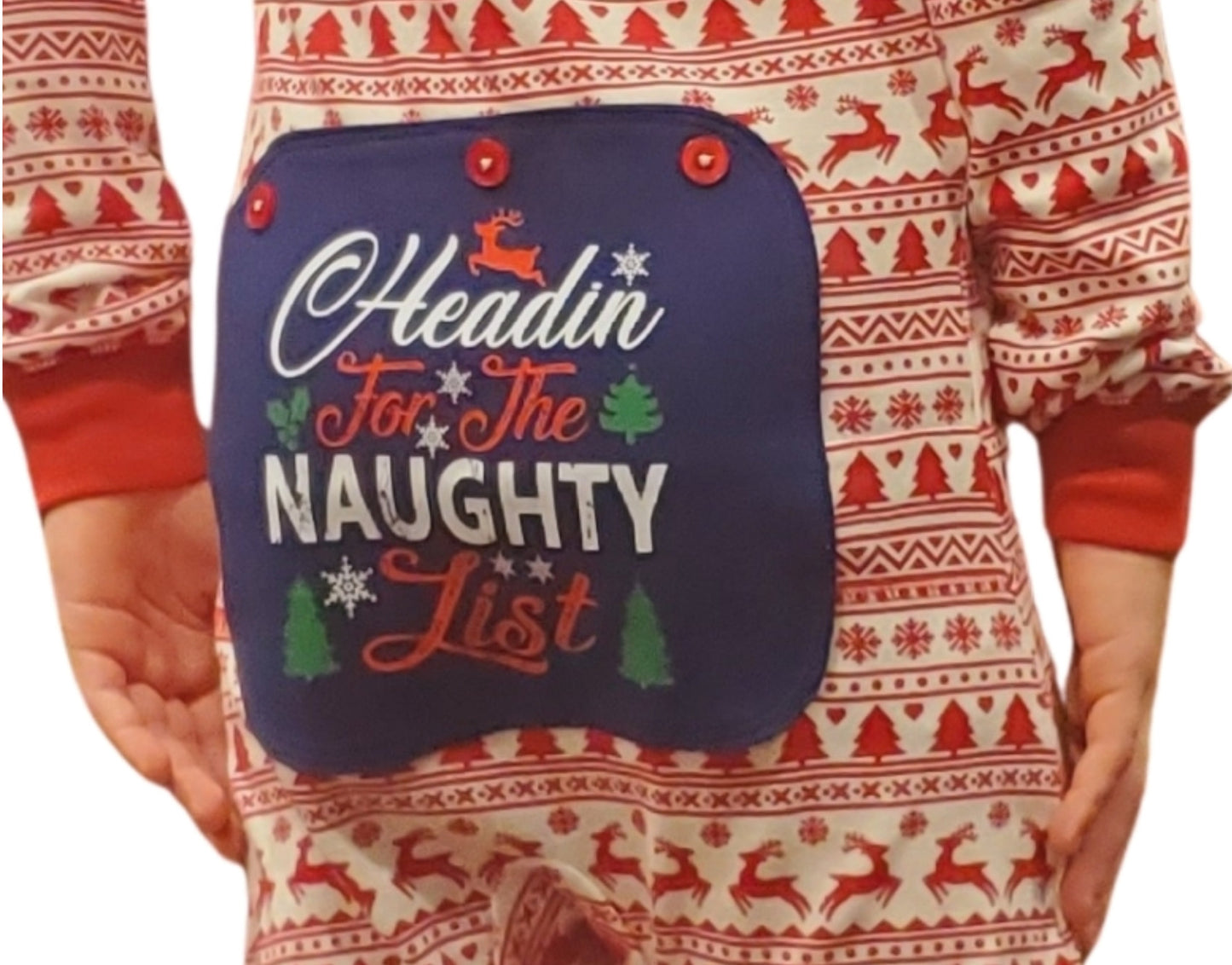A pajama onesie with a festive pattern that features this blue rear flap that reads, "Headin' For the Naughty List" from the Big Feet Pajamas Christmas collection