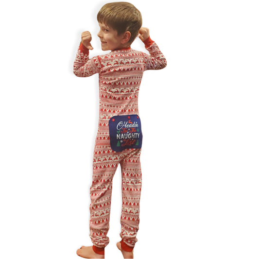 A boy wearing onesie pjs with a festive red & white pattern and features an attached blue rear flap that reads, "Headin' For the Naughty List" from the Big Feet Pajamas Christmas collection